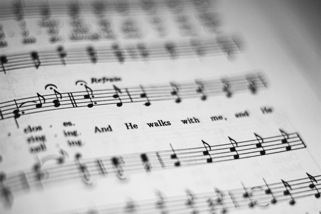 pexels photo 3731014 3731014 Close-up of black and white sheet music featuring musical notes and lyrics in focus.